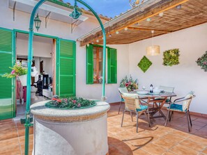 A patio with a dining table, chairs, and a decorative planter. - Casa Vileta by Interhome (Vileta)