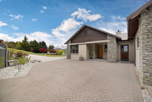 Lake Hayes retreat offers breathtaking mountain and lake views with modern luxury amenities.