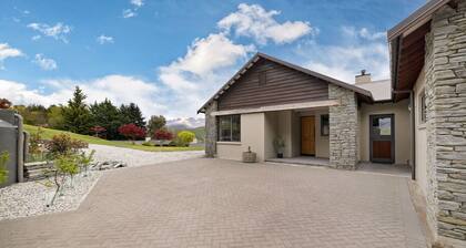 Lake Hayes retreat offers breathtaking mountain and lake views with modern luxury amenities.