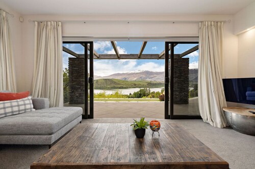 Lake Hayes retreat offers breathtaking mountain and lake views with modern luxury amenities.