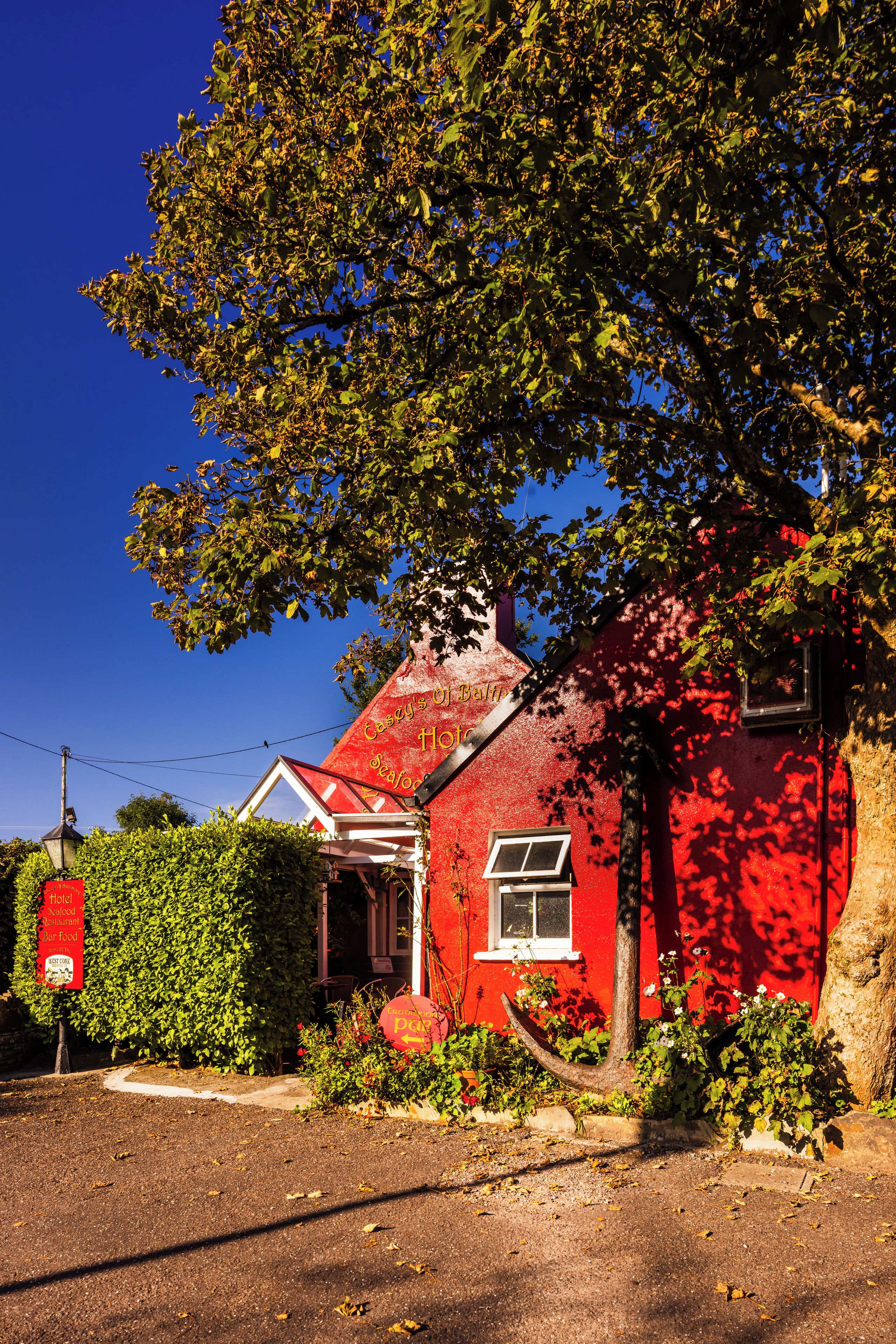 A red building with a sign that says 'Hotel.'