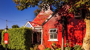 A red building with a sign that says 'Hotel.'