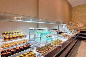 Um buffet com diversos doces e bebidas.