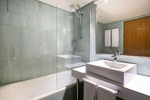 A modern bathroom with a glass-enclosed shower, a white sink, and a large mirror. - Comfort Inn Ponta Delgada (Ponta Delgada)