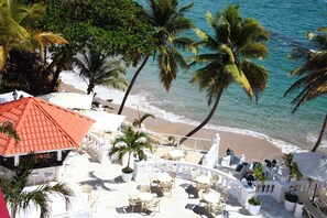A beachside resort with outdoor seating, palm trees, and a view of the ocean. - Bahia Principe Escape Samaná Hyatt Incl Co Adult O (Samaná)