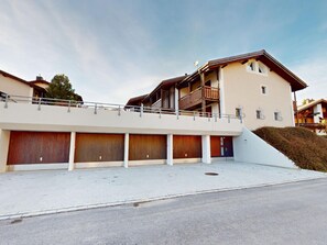 A multi-story building with a flat roof, a balcony, and a garage entrance. - 1905 Tgampi Sot Lantsch/Lenz by Interhome (Lantsch)