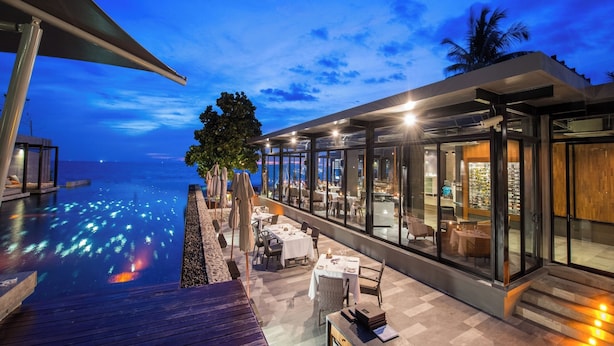 A modern outdoor dining area with a pool, overlooking the sea. - Aleenta Phuket - Phang Nga Resort and Spa (Takua Thung)
