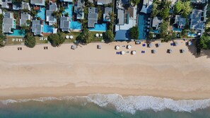 An aerial view of a beachside resort with multiple swimming pools, sun loungers, and a sandy beach. - Aleenta Phuket - Phang Nga Resort and Spa (Takua Thung)