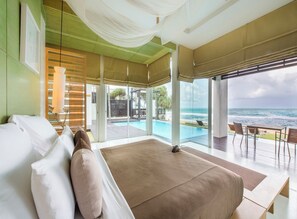 A bedroom with a large bed, a view of the ocean, and a pool area. - Aleenta Phuket - Phang Nga Resort and Spa (Takua Thung)