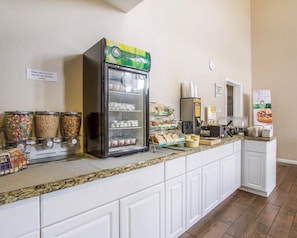 A self-service breakfast station with cereal, milk, and other food items. - Quality Inn Flagstaff East I-40 (Flagstaff)