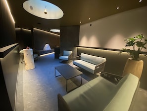 A modern lounge area with seating, a coffee table, and a plant. - 1303 Krone Churwalden by Interhome (Churwalden)