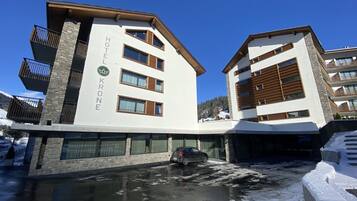 Ein Hotel im modernen Stil, mit einer Steinfassade und mehreren Balkonen.