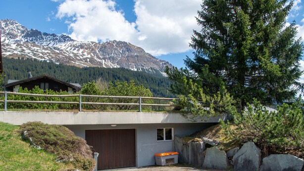 A modern building with a wooden deck overlooking a mountainous landscape. - 1507 Davos Lai Valbella by Interhome (Valbella)