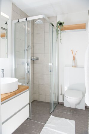 A modern bathroom with a glass-enclosed shower, a white sink, and a toilet. - 1619 Sundroina Prada C by Interhome (Lenzerheide)