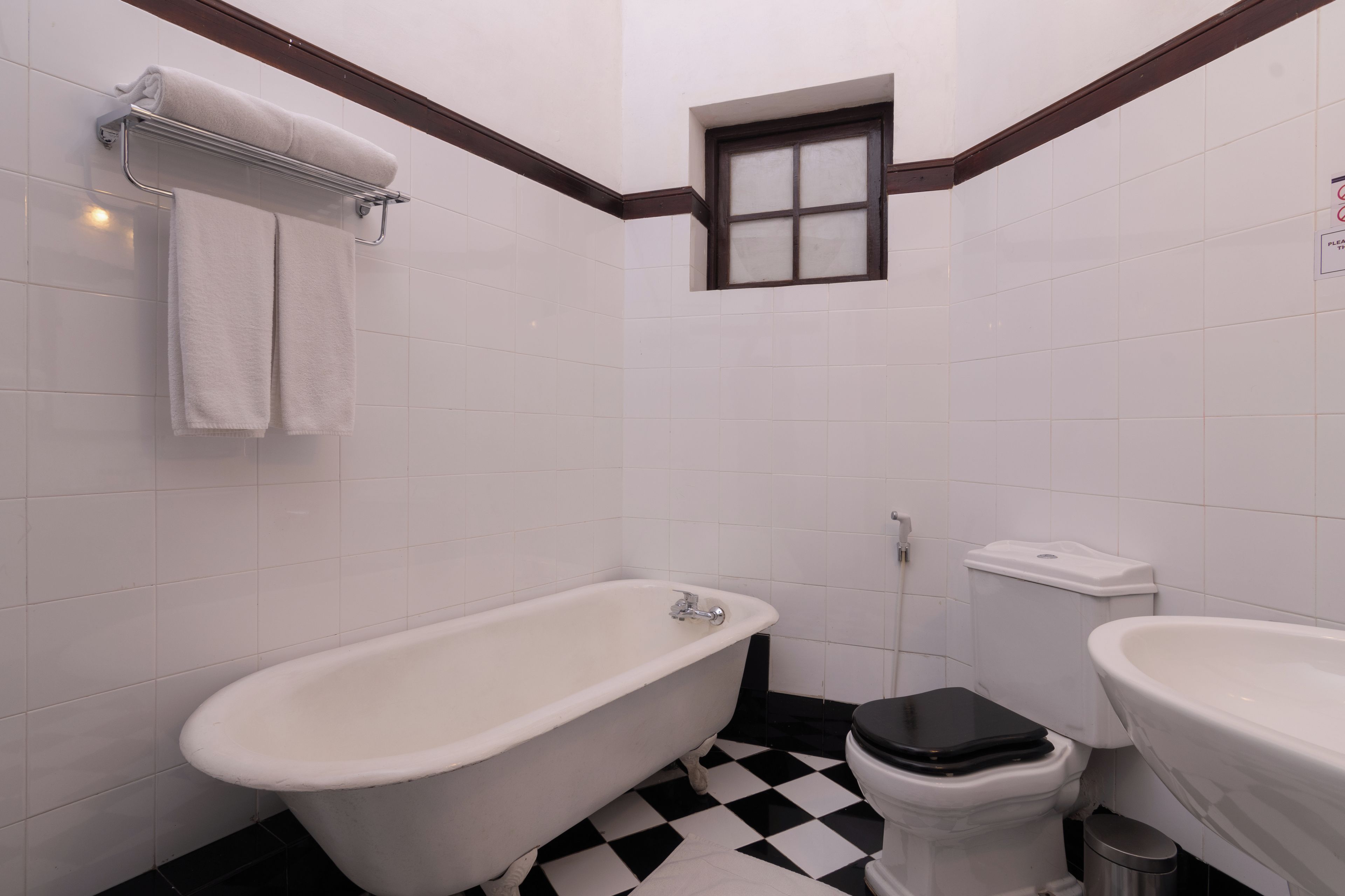 A bathroom with a clawfoot bathtub, a toilet, and a sink.