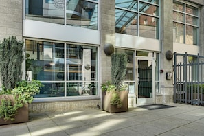 A modern building with large windows, a glass entrance, and potted plants. - Best capital hill  location studio close to fun w/
free parking / fitness center (Seattle)