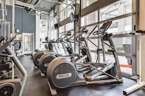 A gym with treadmills, stationary bikes, and weight machines. - Best capital hill  location studio close to fun w/
free parking / fitness center (Seattle)