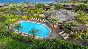 A resort with a swimming pool, lounge chairs, and a view of the ocean. - The Kapalua Villas Maui by Outrigger (KAPALUA)