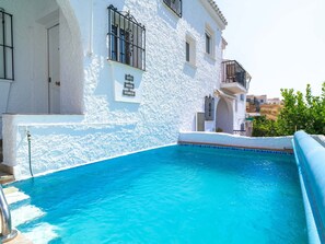 A swimming pool with a white building in the background. - Casa Lovisa Private Pool by Casasol by Interhome (Nerja)