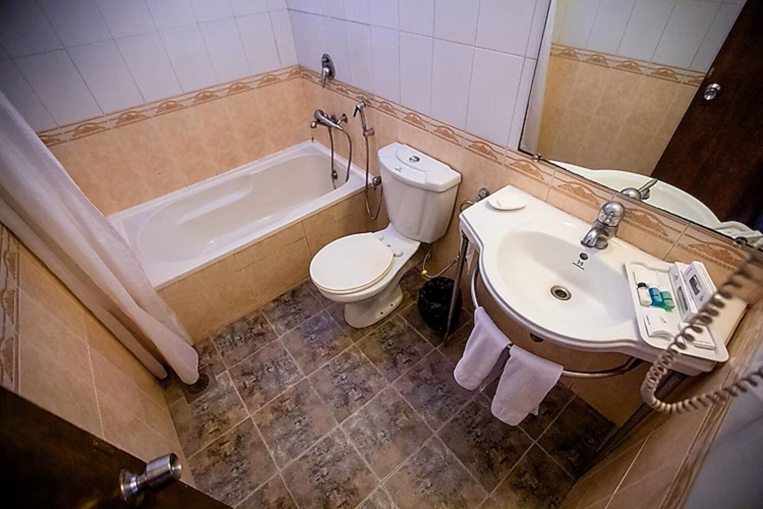 A bathroom with a bathtub, toilet, and sink.