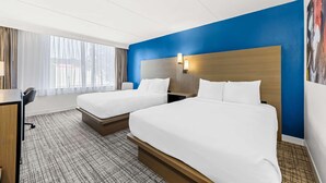 A hotel room with two beds, a desk, and a large window. - Best Western Plus Lower South End (Charlotte)