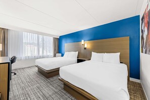 A hotel room with two beds, a desk, and a large window. - Best Western Plus Lower South End (Charlotte)