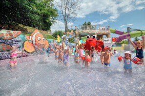 A water park with a large inflatable character, a water slide, and a pool area. - Grifid Hotel Bolero (Varna)