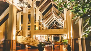 A spacious lobby with a grand staircase, high ceilings, and modern lighting fixtures. - Mission Hills Phuket Golf Resort & Spa (Wichit)