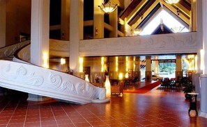A grand lobby with a sweeping staircase, high ceilings, and a large open space. - Mission Hills Phuket Golf Resort & Spa (Wichit)