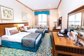 A hotel room with two beds, a desk, a mirror, and a window with curtains. - Orchid Hotel Al Barsha Formerly Golden Tulip Al Ba (Dubai)