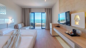 A hotel room with a bed, a desk, a TV, and a balcony with a view.