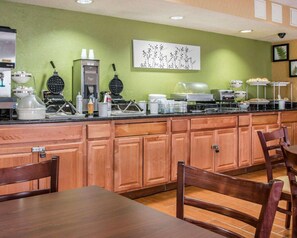 A breakfast bar with waffle makers, coffee machines, and a water dispenser. - Sleep Inn & Suites (Grand Rapids)