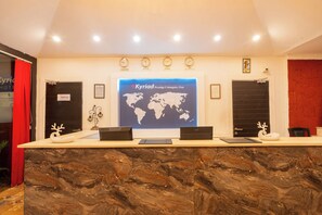 A reception desk with a world map, clocks, and a 'Start Only' sign. - Kyriad Prestige Calangute Goa by Othpl (Calangute)