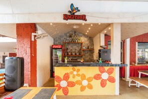 A restaurant with a tiled counter, a Coca-Cola sign, and a sign reading 'Kingfisher'. - Kyriad Prestige Calangute Goa by Othpl (Calangute)