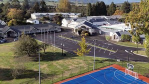 A residential area with houses, a parking lot, and a basketball court. - Wairakei Resort Taupo (Wairakei)