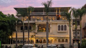 A building with a traditional architectural style, featuring multiple balconies and a sign indicating it is a hotel. - Panna Villas Udaipur (Udaipur)