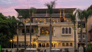 A building with a traditional architectural style, featuring multiple balconies and a sign indicating it is a hotel. - Panna Villas Udaipur (Udaipur)