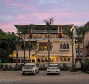 A building with a traditional architectural style, featuring multiple balconies and a sign indicating it is a hotel. - Panna Villas Udaipur (Udaipur)