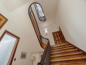 A wooden staircase with a curved railing and a door at the top. - Apartment  by Interhome (Porto)