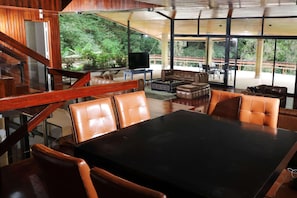 A modern interior with a dining area, leather seating, and a view of the outdoors. - Hotel Bambito By Faranda Boutique, A Member Of Rad (Cerro Punta)