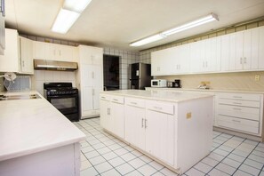 A kitchen with white cabinets, a stove, a microwave, and a refrigerator. - Hotel Bambito By Faranda Boutique, A Member Of Rad (Cerro Punta)