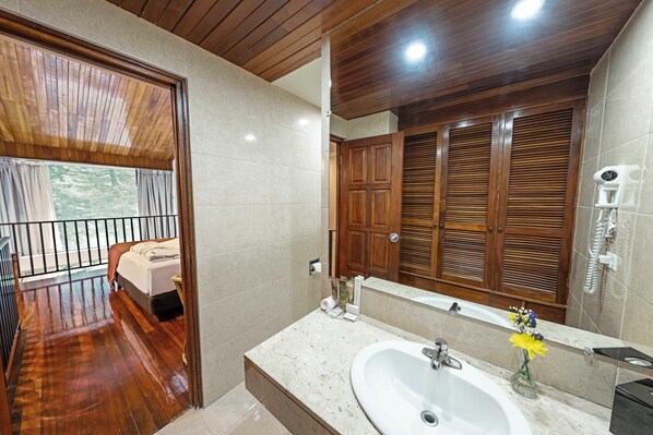A bathroom with a wooden ceiling, a large mirror, a sink, and wooden cabinets. - Hotel Bambito By Faranda Boutique, A Member Of Rad (Cerro Punta)