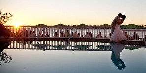 A wedding ceremony at sunset with a reflective pool in the foreground. - Ocean Key Resort & Spa (Key West)