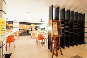 A restaurant with tables and chairs, a coffee shop sign, and a menu board. - The Vogue Hotel, Pattaya (Pattaya)