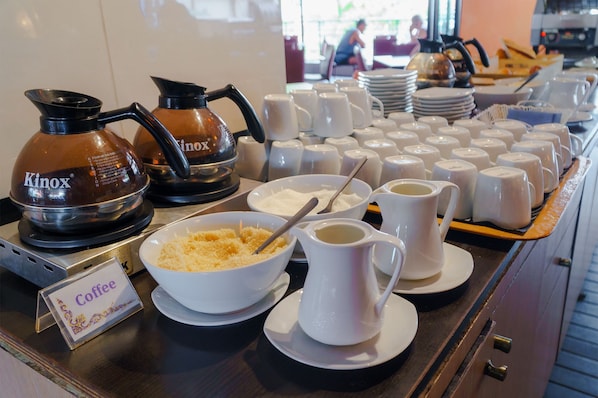 A coffee station with KINOX coffee makers, a bowl of cereal, and a pitcher of coffee. - The Vogue Hotel, Pattaya (Pattaya)