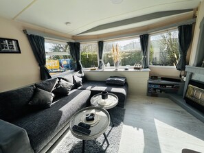 A living room with a sofa, a coffee table, and a fireplace. - RBR 1747 - Beach Resort Kamperland by Interhome (Kamperland)