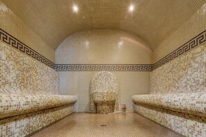 A tiled bathroom with a curved ceiling and two sinks. - Hotel Shipka All Inclusive (Varna)