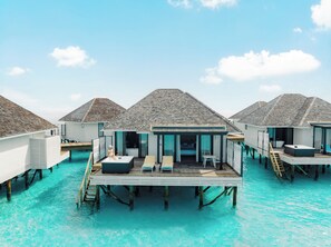 Overwater bungalows with private pools, wooden deck structures, and lounge chairs. - Nova Maldives (Malé)