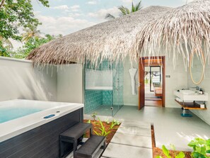 A modern bathroom with a glass shower, a bathtub, and a sink. - Nova Maldives (Malé)