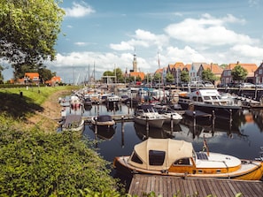 A marina with boats docked, a church with a tower, and traditional buildings with red roofs. - RBR 164 - Beach Resort Kamperland by Interhome (Kamperland)